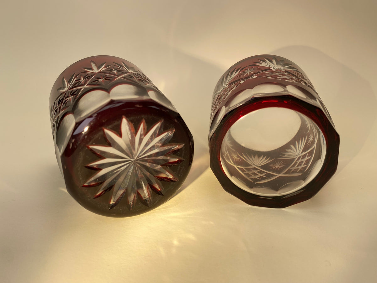 Close-up of Option A, a Japanese vintage red Kiriko cut glass tumbler with a starburst and crosshatch pattern.