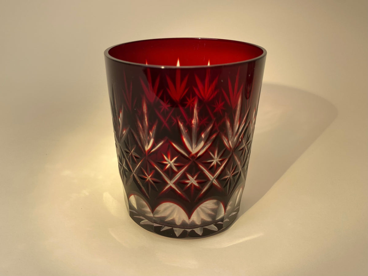 Close-up of Option B, a Japanese vintage red Kiriko cut glass tumbler with a fan and diamond pattern and octagonal faceted base.