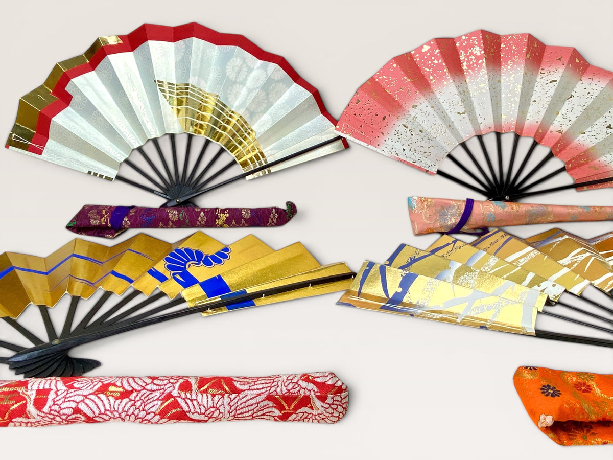 Option A: Vintage Japanese folding fan with red to white gradient and gold flecks beside a purple brocade carry bag.