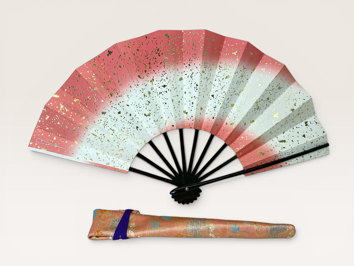 Option B: Vintage Japanese folding fan with pink to white gradient and gold flecks beside a peach floral carry bag.