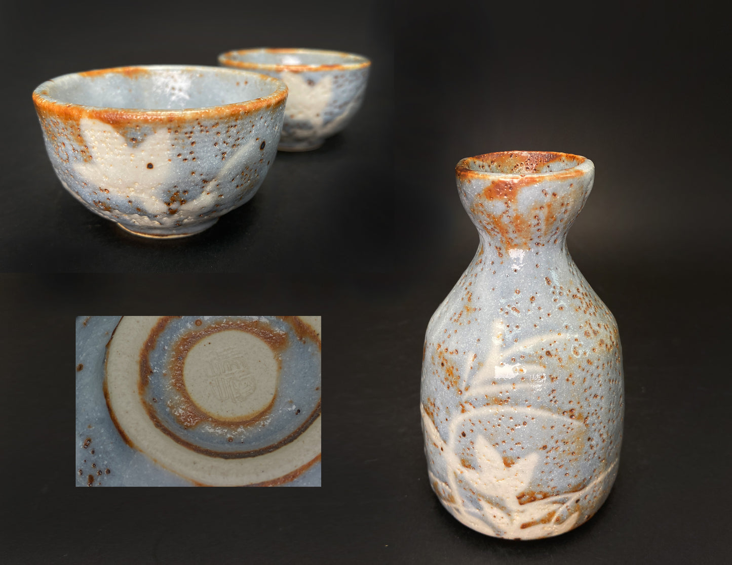 Group photo of handmade Japanese Nezumi Shino Mino ware sake set showing tokkuri bottle and two sake cups with blue-grey glaze, rust iron spots, white plant patterns, and artist signature on cup base
