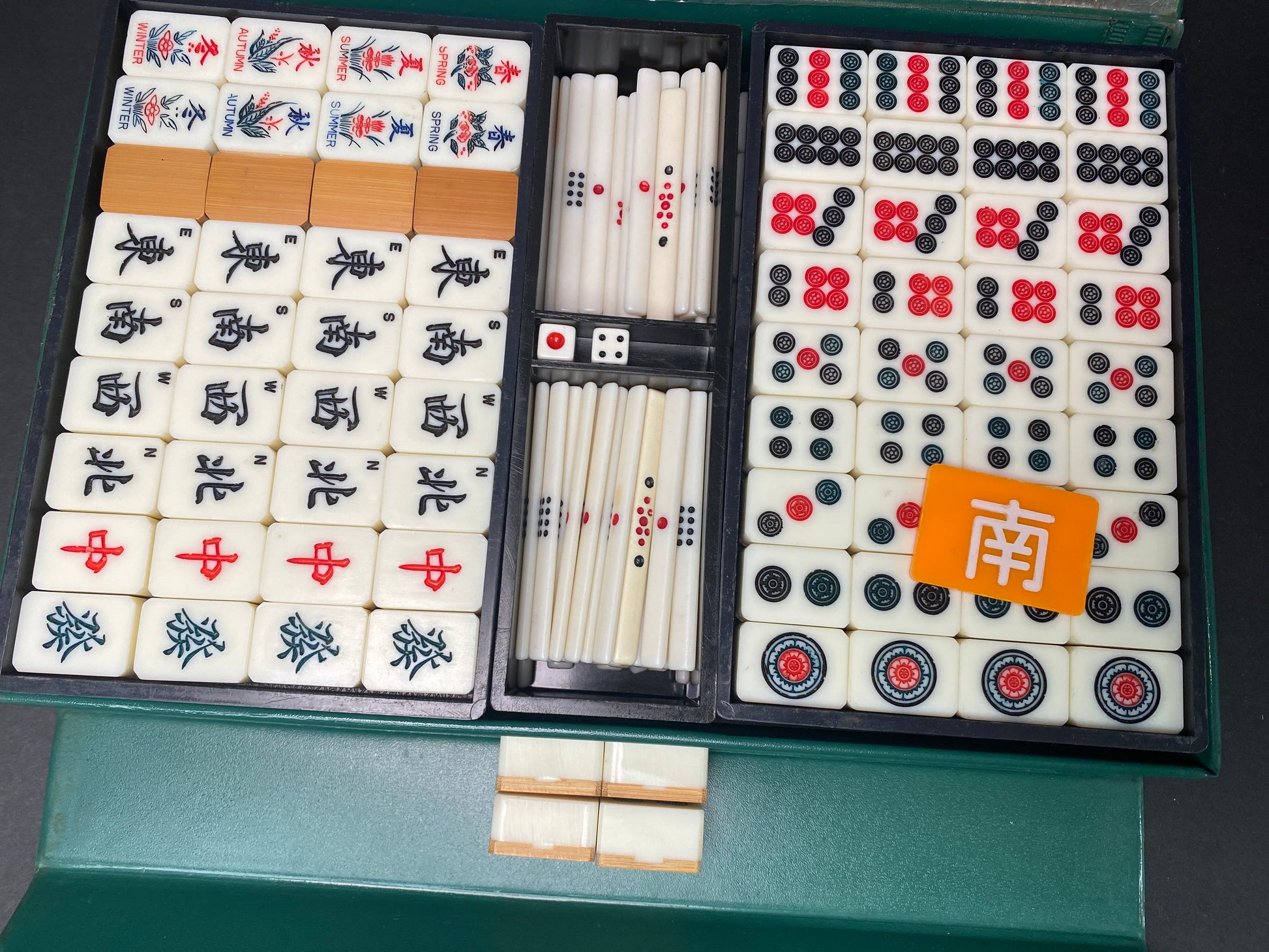 Interior trays holding vintage Japanese mahjong tiles in organized rows