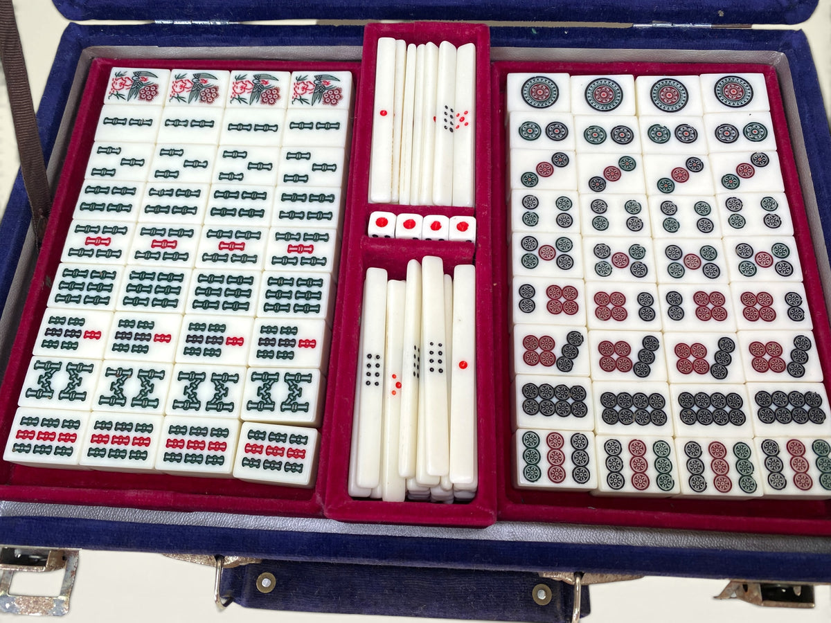 Close view of Japanese mahjong instruction booklet with Japanese text inside blue velvet case